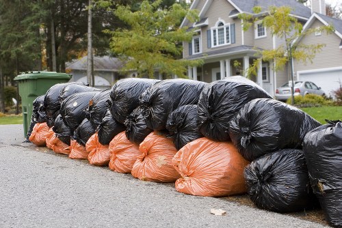 Waste workers sorting commercial rubbish with safety gear